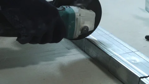 Closeup of sparks from circular grinding machine cutting metal profile in Stock Footage 91830068