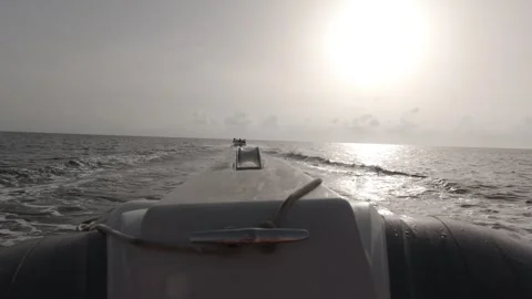 A closeup of a speedboat ploughing through the waves at sunrise Stock-Footage 243038145