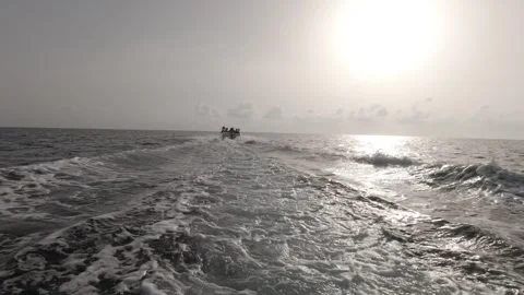 A closeup of a speedboat ploughing through the waves at sunrise Stock-Footage 243038322