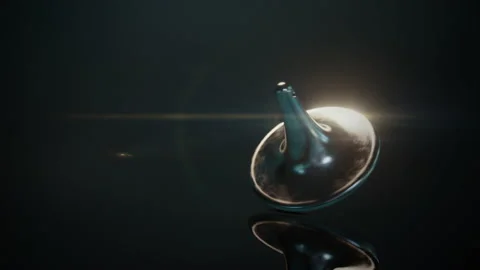 The closeup of a spinning top spins Stock Footage 195822286