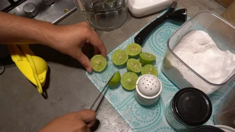 Closeup splitting a lemon with a knife in the kitchen in 4k Stock Footage 199517925