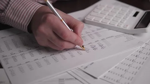Closeup Of Spreadsheet With Calculator And Pen, Focused Professional Examining Stock Footage 323924029