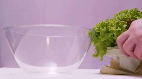 Closeup of spring fresh green salad leaves in a bowl. Process of prepar Video stock 310723410