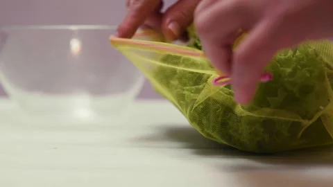 Closeup of spring fresh green salad leaves in a bowl. Process of prepar Video stock 310723515