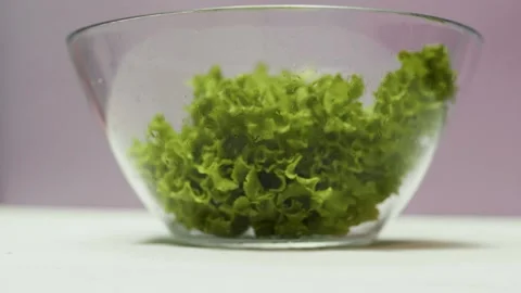 Closeup of spring fresh green salad leaves in a bowl. Process of prepar Video stock 310723540