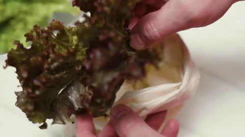 Closeup of spring fresh green salad leaves in a bowl. Process of prepar Video stock 310723544