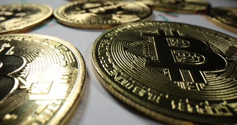 Closeup of stack of Bitcoin cryptocurrency coins with graph Stock Footage 273473842