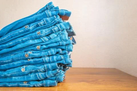 Closeup of stack of blue jeans. Stock Photos