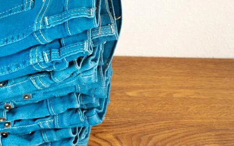 Closeup of stack of blue jeans. 库存照片