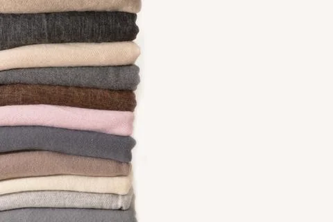 Closeup Stack of folded different colorful knitted on white background Stock Photos