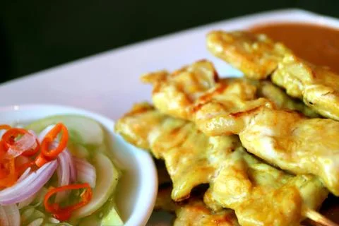 Closeup Stack of Grilled Pork Satay with Spicy Pickled Vegetable Stock Photos