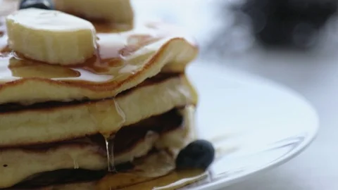 Closeup of stack of pancakes with pouring honey Stock Footage 79130644