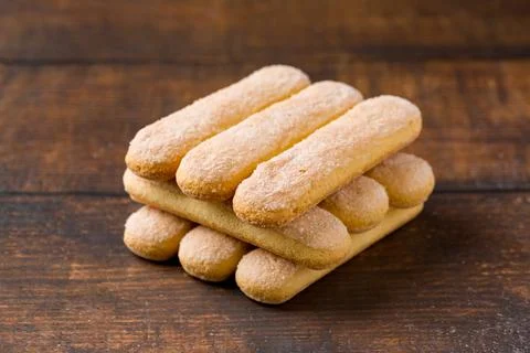 Closeup stack of Savoiardi ladyfinger biscuits on rustic wooden table Stock Photos