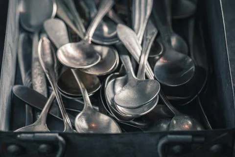 Closeup of stack of spoons in a metal box Foto stock