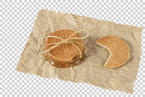 Closeup of a stack of stroopwafels on a brown paper, next to another biscuit  Stock Photos
