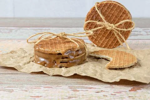 Closeup of a stack of stroopwafels with a sisal bow, next to another biscuit  Stock Photos