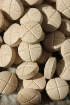 A closeup of a stack of tablets with X of them Stock Photos