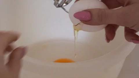Closeup of stand mixer mixing Egg whites. Egg being poured into bowl. Stock Footage 114578973