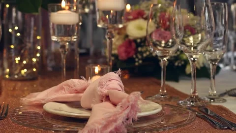 Closeup static shot of place setting with candles and pink napkin Stock Footage 160830016
