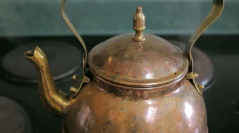 Closeup of Steam Boiling From a Copper Tea Kettle on a Stove Top Stock Footage 64111531