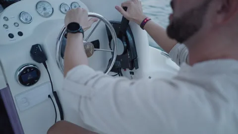 Closeup of the steering wheel of a boat driven by a man Stock Footage 265909194