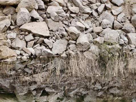 Closeup of stone reflection showcasing complex textures and natural silhoue.. Fotos de archivo