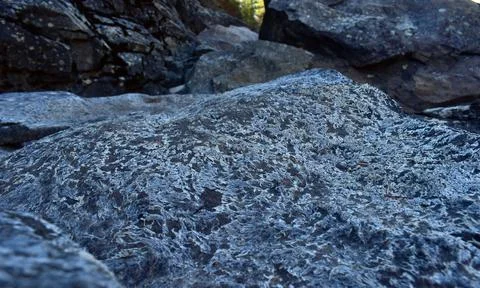 Closeup of a stone surface against the cliffs background Stock Photos