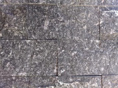 Closeup of a stone wall background texture Stock Photos