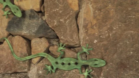 Closeup of a stone wall with patterned fake lizards in a country house in 4k Stock-Footage 199471753