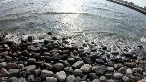 Closeup of a stony beach at evening. Stock Photos