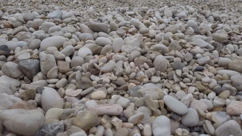 Closeup of a stony beach, multi coloured beach pebbles Stock Footage 124007077