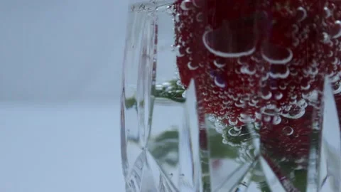Closeup of strawberry in sparkling water Stock Footage