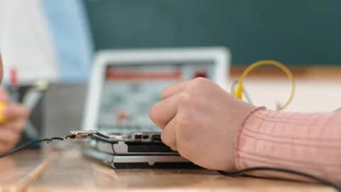 Closeup of student hands fixing main board while teacher teach prompt. Pedagogy. Stock Footage 275618017