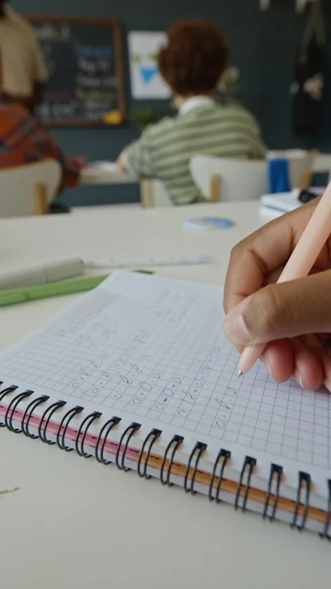 Closeup of Student Writing Math Equations in Notebook during Class Stock Footage 340552306