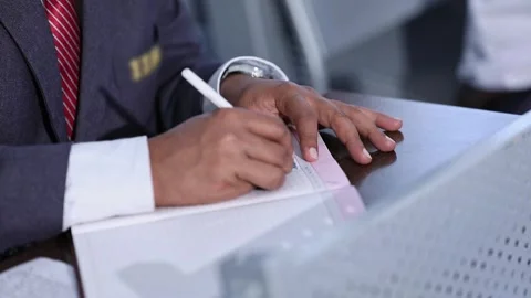 Closeup of a student writing notes with pen inside the collage classroom Video stock 313257171