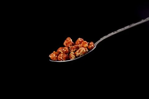 Closeup of sugar peanuts on a black background Stock-Fotos