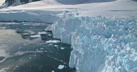 Closeup sun reflection ocean aerial. Melting ice, snow of glacier coast. Climate Stock Footage 148359878