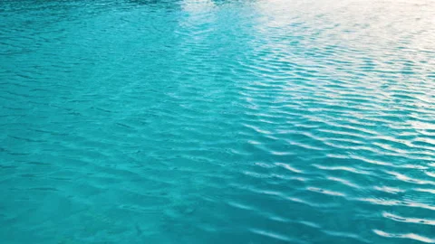 Closeup surface of blue clear water with small ripple waves in swimming pool Video stock 167395184