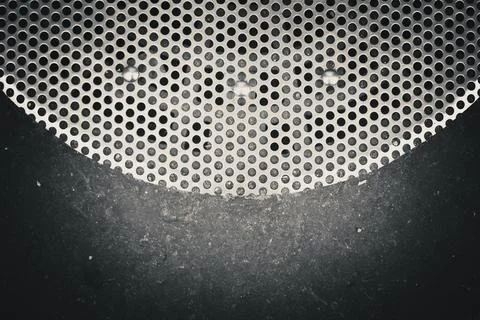 Closeup of a surface with a pattern of circular holes in a metal grille or .. Fotos de archivo