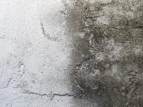 Closeup of the surface of a rough cement wall with black and white colors due to Stock Photos