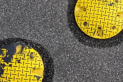 A closeup surface texture of an old asphalt road with speed bump in northern  Stock Photos