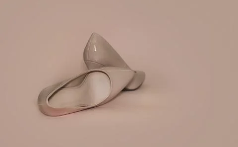 Closeup surface view of high heeled beige shoes on a beige background. Foto stock
