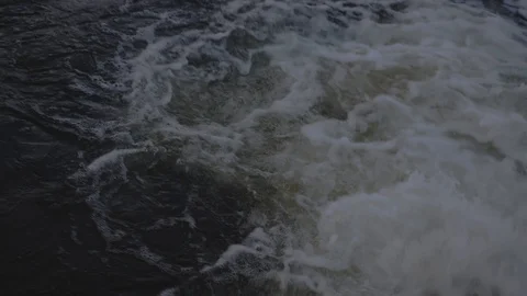 Closeup of the surface of the water with the lights of the night city. Recorded Video stock 120119098