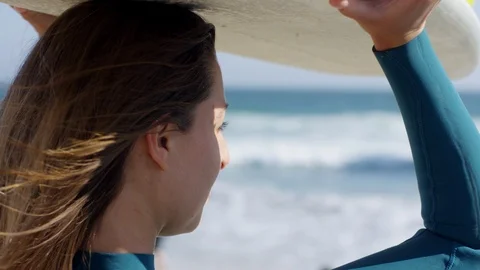 Closeup Of Surfer Watching The Waves, She Balances Her Surfboard On Her Head Stock Footage 92487996