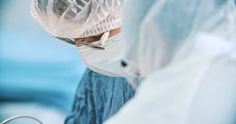 A closeup of surgeon faces during operation. Medicine, surgery, health care Stock Footage 121096584