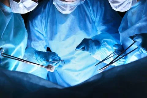 Closeup of surgeons performing operation. Focus on human hands using Stockfoto's