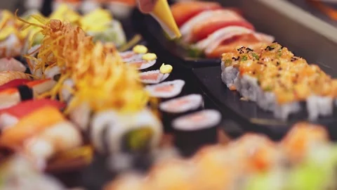 Closeup of Sushi chef hands squeeze sushi sauce Stock Footage 130673382