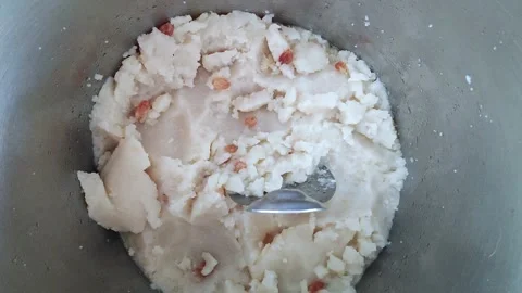A closeup of a sweet dish called prasadam or prasad served at a temple Vidéo 243577848