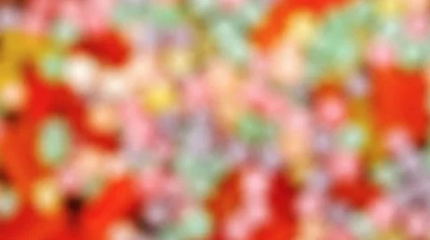 Closeup swipe of colorful hard candy, first blurry then focused Stock Footage