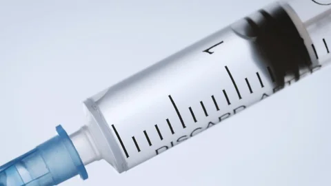 Closeup of a Syringe Injecting a Vaccine Stock Footage 106901164